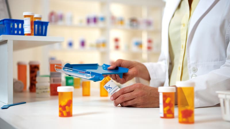 pharmacist checking the label of the medicine