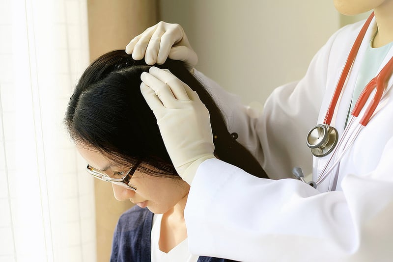 dermatologist checkup the head of a woman