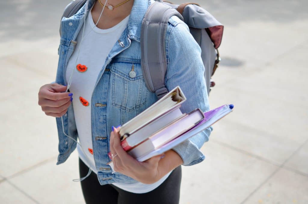 a young lady carrying books