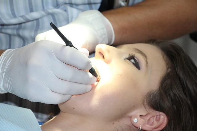 woman receiving treatment from a dentist